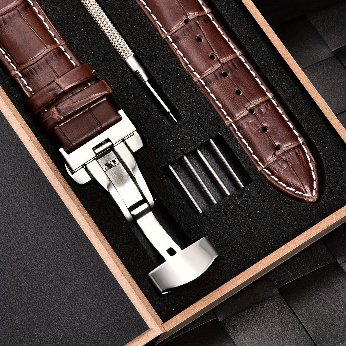 Watchband made of PU leather with stainless steel butterfly deployment buckle clasp, available in sizes 18mm, 20mm, 22mm, and 24mm, comes with a box.