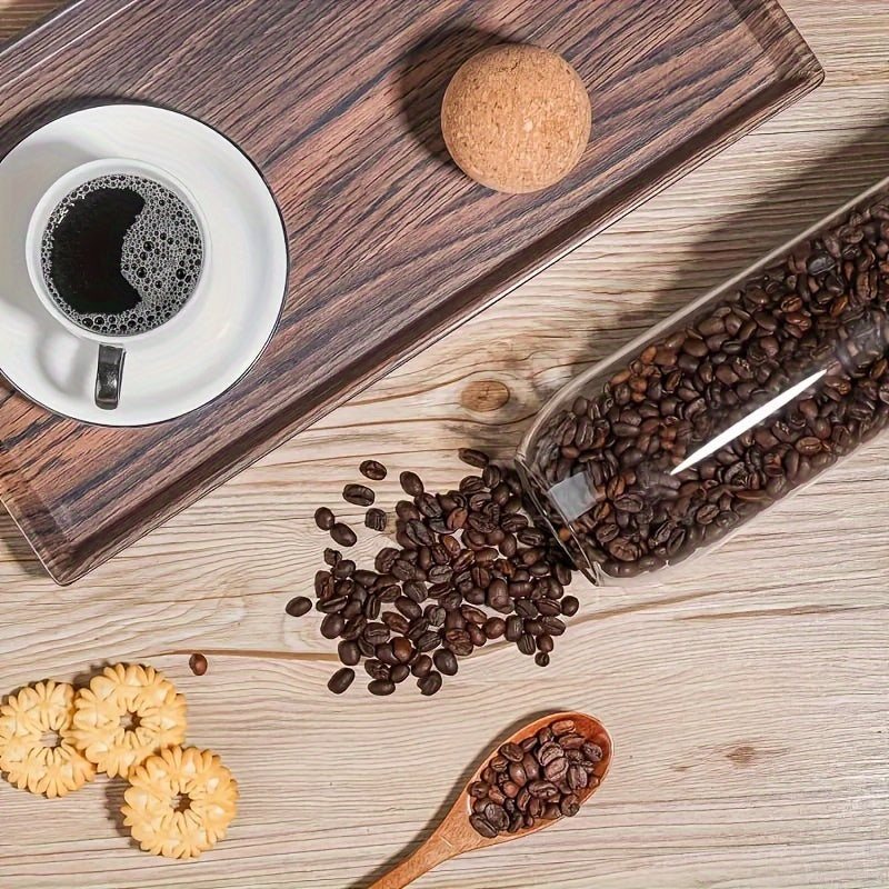 Airtight glass kitchen jars with cork lids for coffee, tea, and spices.