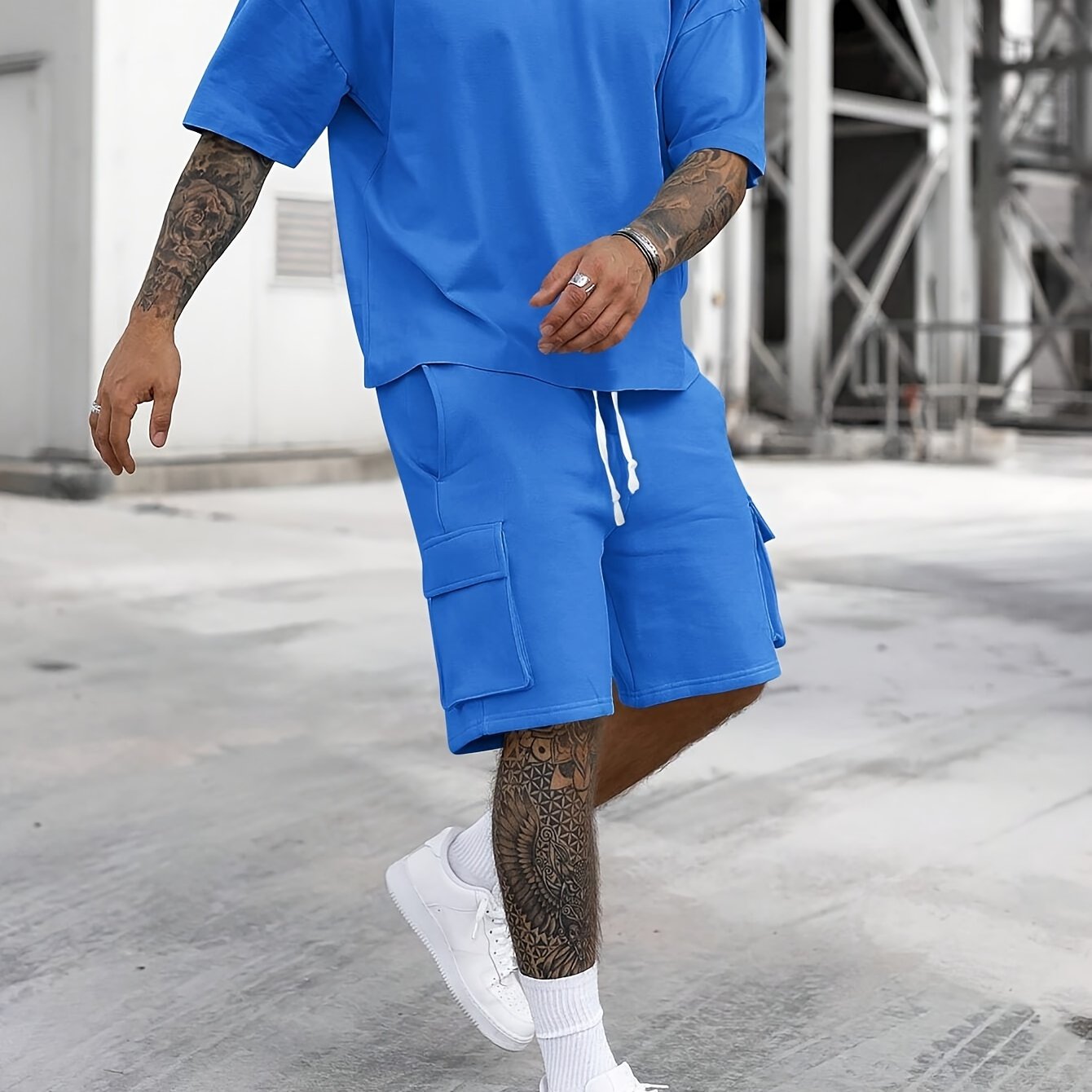 Men's casual sportswear set includes polyester t-shirt and drawstring shorts with pockets, ideal for summer and machine washable.