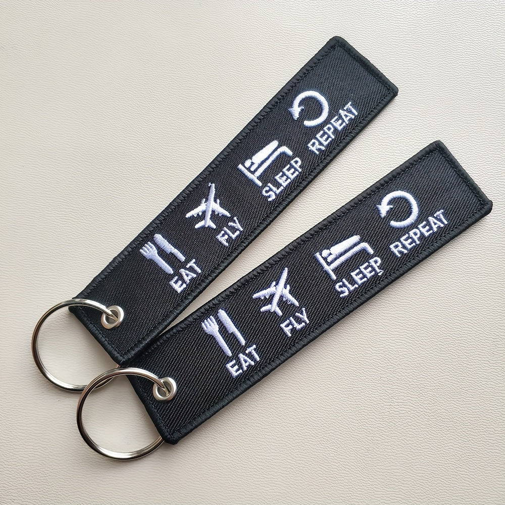 Set of three 'Eat Fly Sleep Repeat' keychains with embroidered design. Ideal gift for pilots, aviation enthusiasts, or anyone with a sense of humor. Keychains come in black and white color combination.