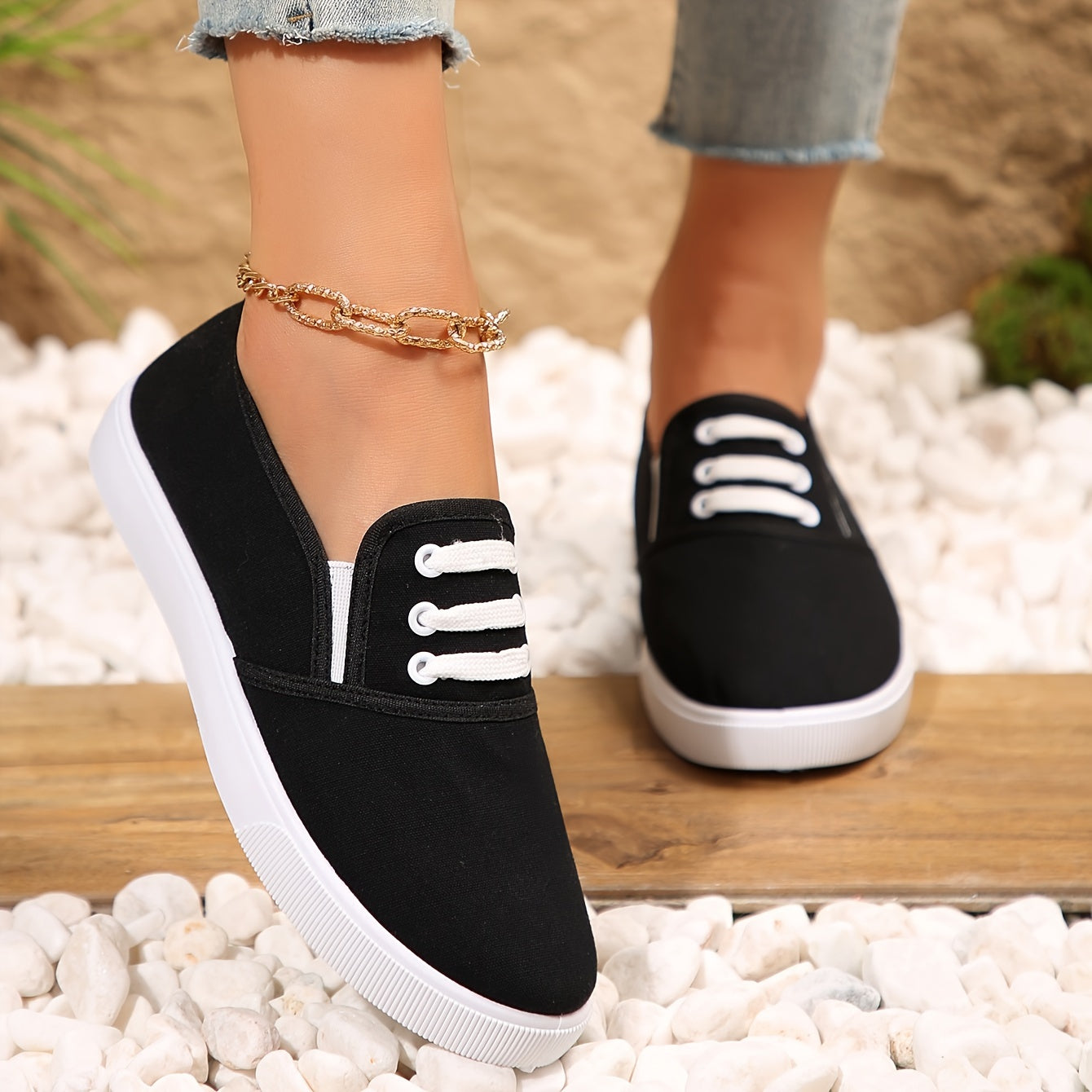 Lightweight white slip-on canvas sneakers for women with a soft sole and minimalist design.