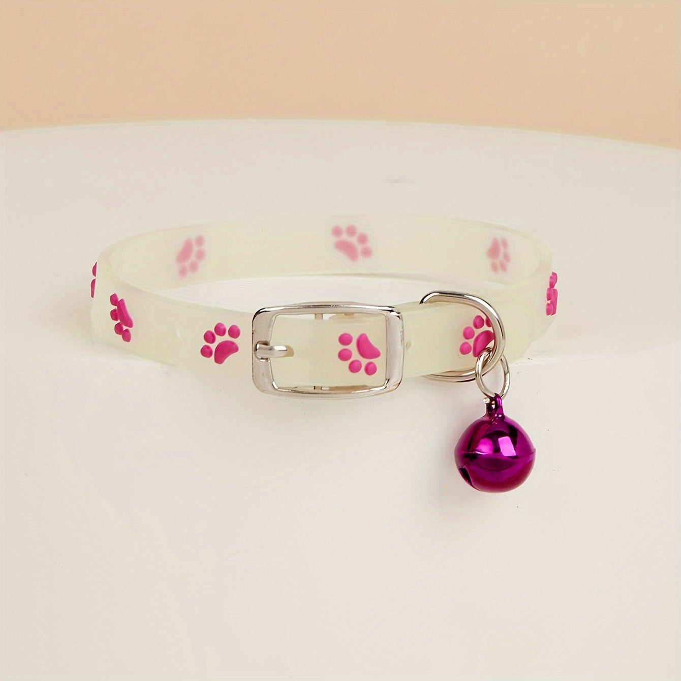 Adjustable glow-in-the-dark cat collar with colorful paw print for easy spotting at night.