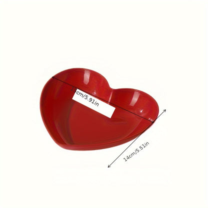 Heart-shaped plastic serving saucers in red for special occasions.