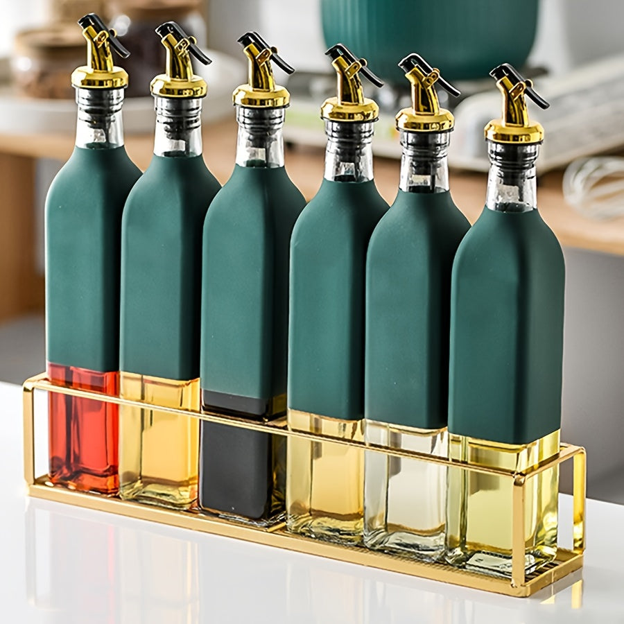 Set of glass dispenser bottles for olive oil and vinegar with a golden pour spout. Hand wash only, PVC free. Includes 6 rectangular cruets with a storage holder rack.