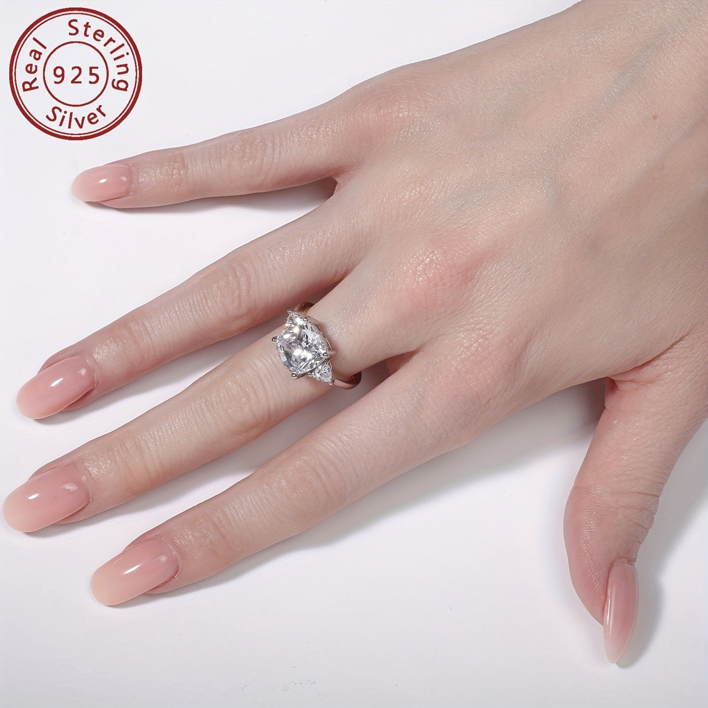 This stunning engagement ring features an elegant design with sparkling 3-stone synthetic cubic zirconia in square and triangle shapes. Made from 925 sterling silver with a high-polished finish, this ring is perfect for weddings and anniversaries. It