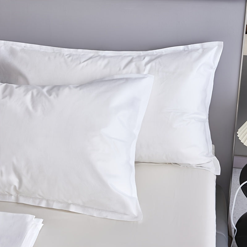 Two pieces of sterile disposable travel pillow covers with sealed envelopes. They are partially cleaned, pure white, and made of thick breathable non-woven polyester. Ideal for travel, hotels, and salons. The covers are unprinted and come in a pair. Use