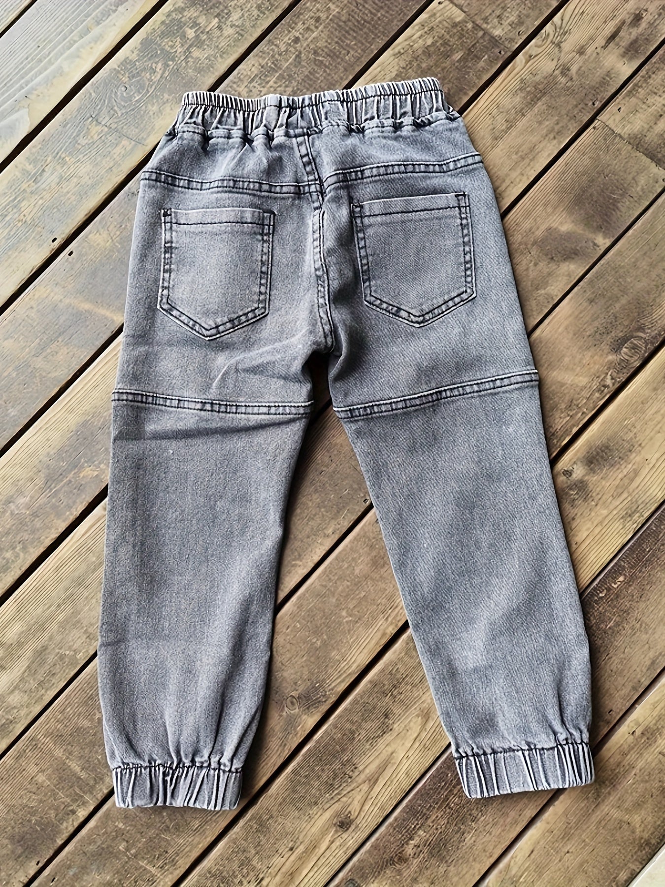 Boys' versatile denim pants with patch detailing for all seasons.