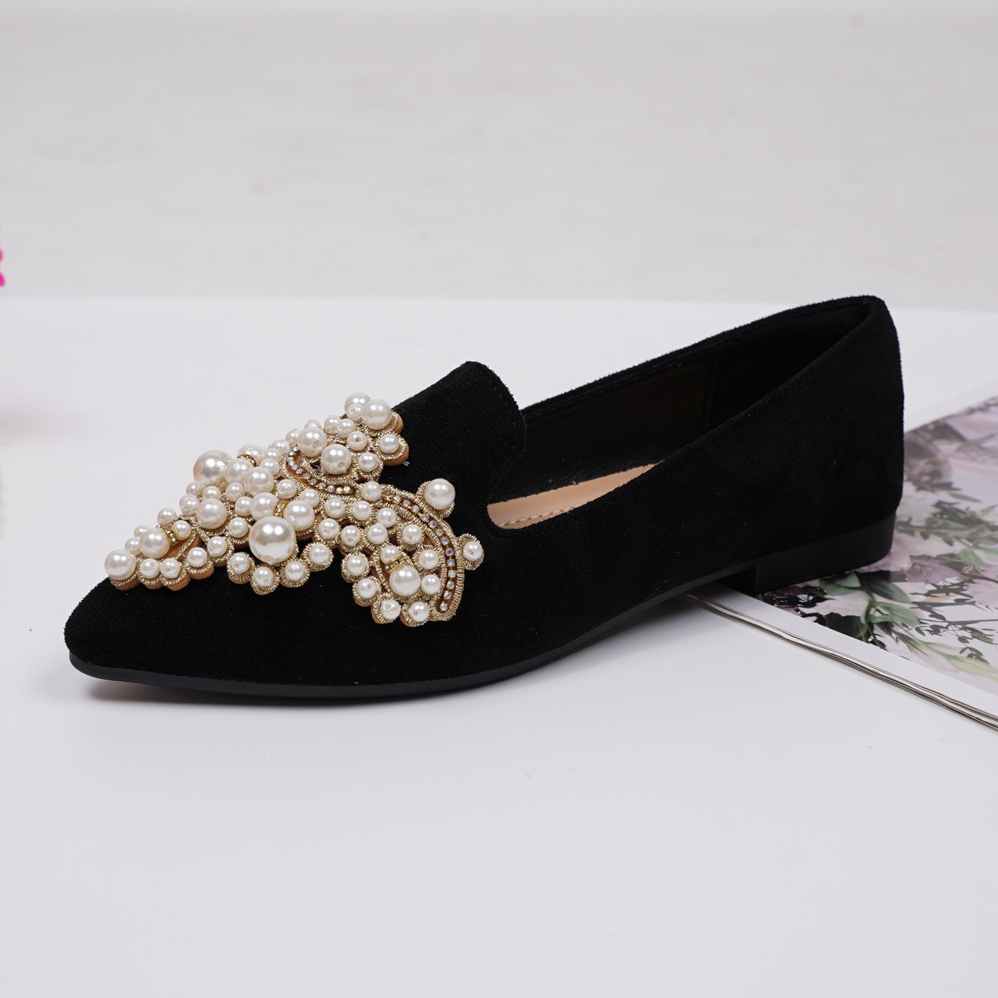 Women's elegant flat shoes with faux pearl decoration, point toe design, and lightweight comfort.