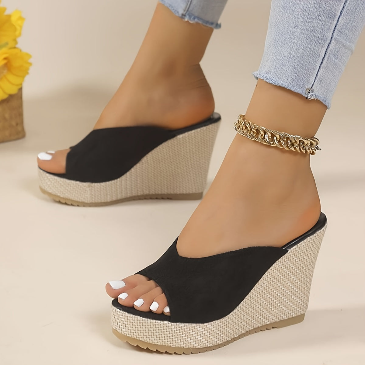 Black slip-on wedge sandals for women with an open toe, high heel, comfortable ankle strap, and woven design sole - perfect for casual summer wear.