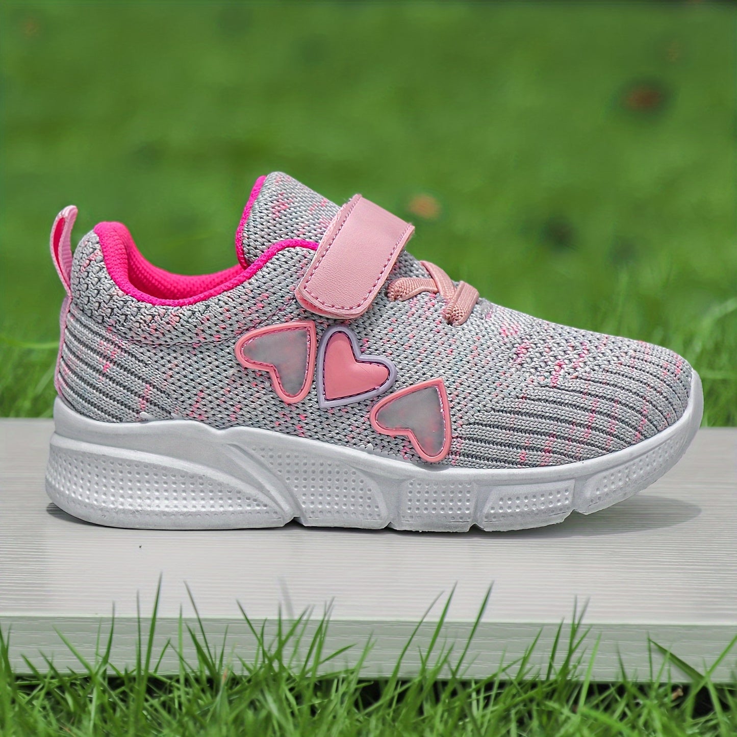 Kids' pink heart design athletic sneakers with breathable knit upper, secure hook-and-loop closure, non-slip rubber sole, perfect for running and walking all year round.