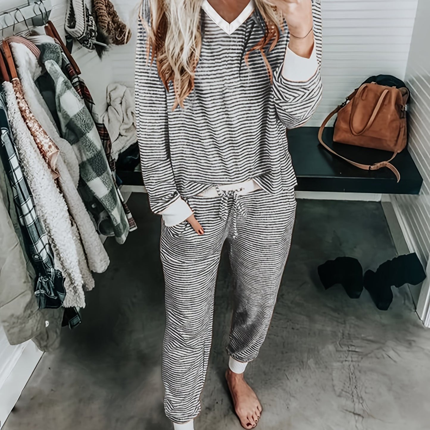 Casual knit pajama set with V-neck, striped design, and drawstring. Made of 95% polyester and 5% elastane for fall/winter home wear. Includes long sleeve top and matching lounge pants.