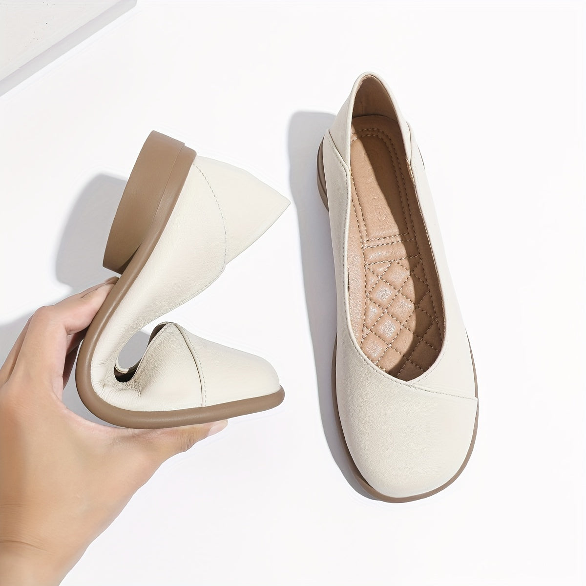 Stylish white low heel flats with all-day comfort for work.