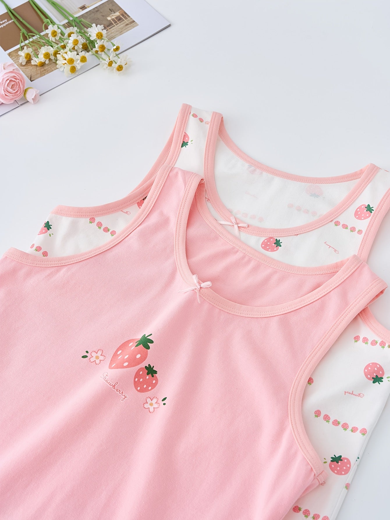 Set of 3 girls' cotton blend tank tops with cartoon patterns, bow detail, and sweat-resistant technology. Suitable for ages 12 and under.