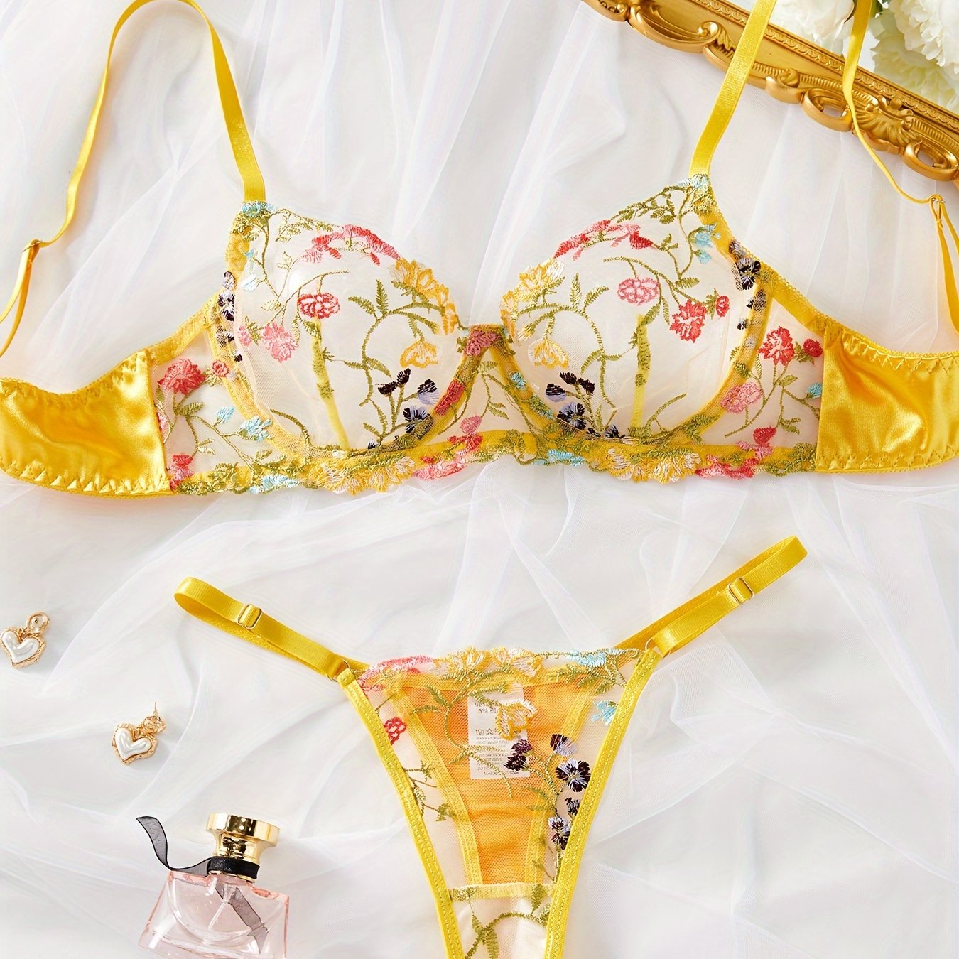 Yellow semi-sheer mesh lingerie set with floral embroidery, including bra and thong. Perfect for a stylish and sexy look.