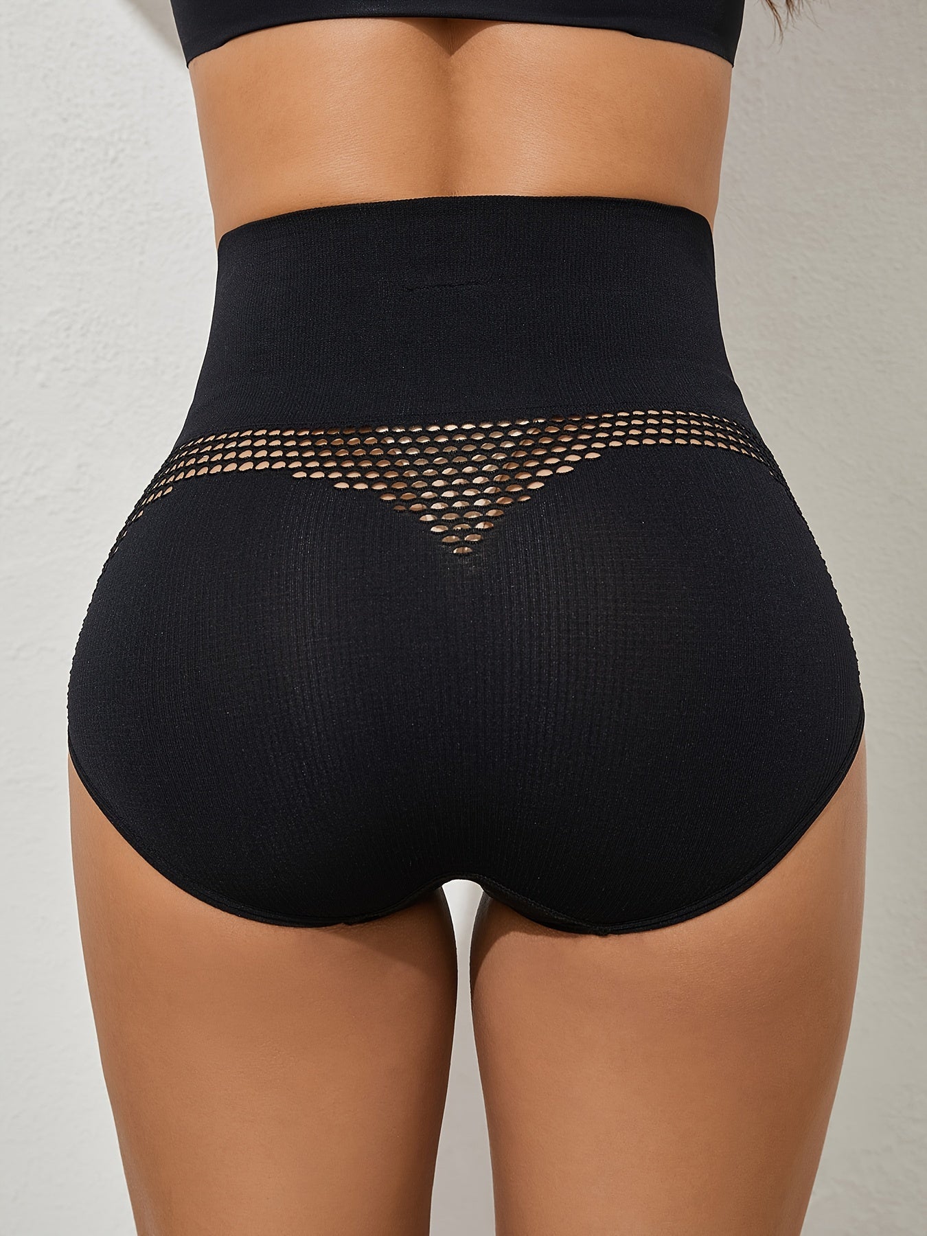 High-waisted tummy control shapewear panties with breathable mesh, perfect for postpartum body shaping. Made of 90% elastane and 10% briefs with hollow detail and knit fabric support.