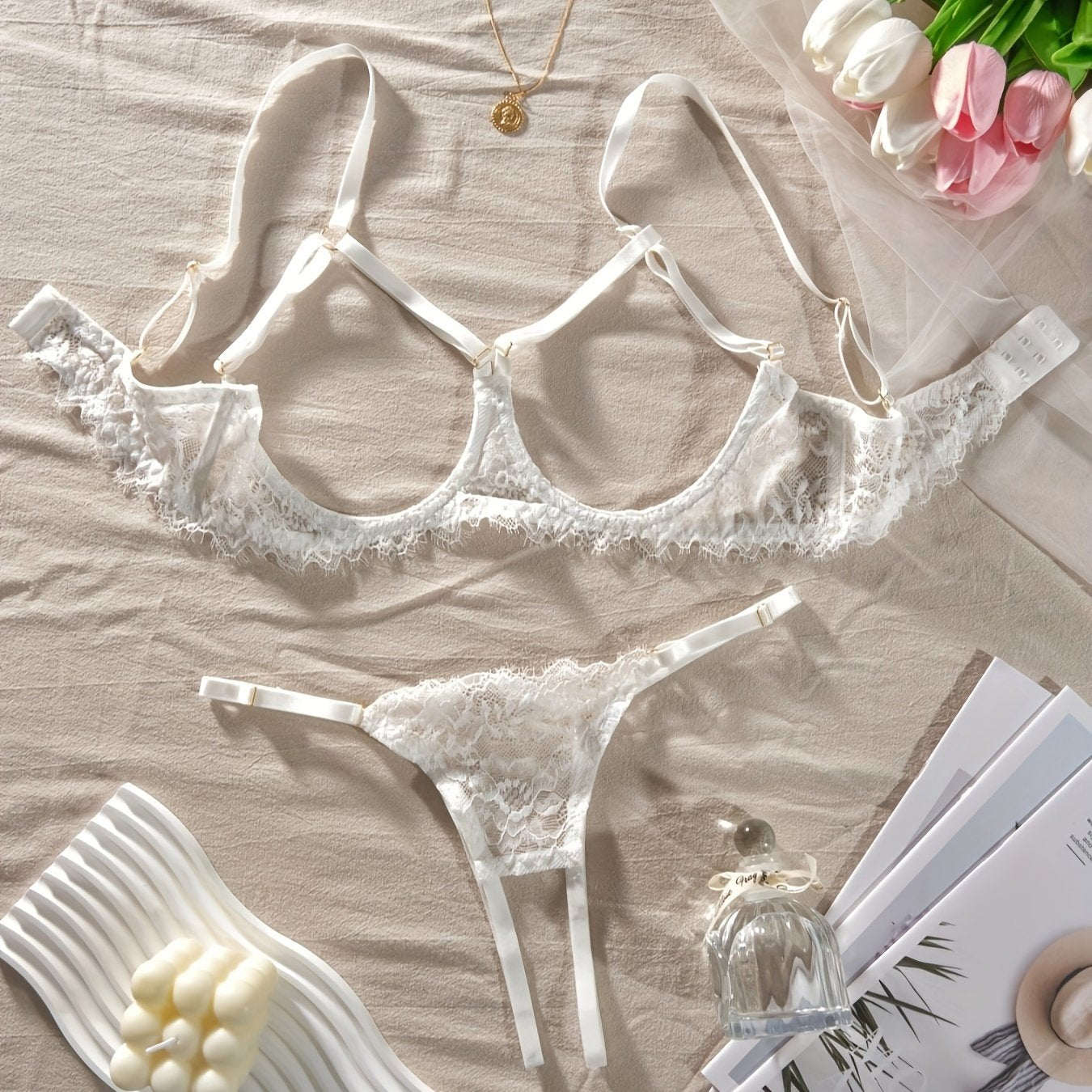 Women's sexy clothing set with open bust bra, open crotch thong, and floral lace design.