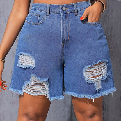 Women's high-waisted denim shorts by Kiki Angel Brand in light blue with ripped details, frayed hem, and slash pockets.