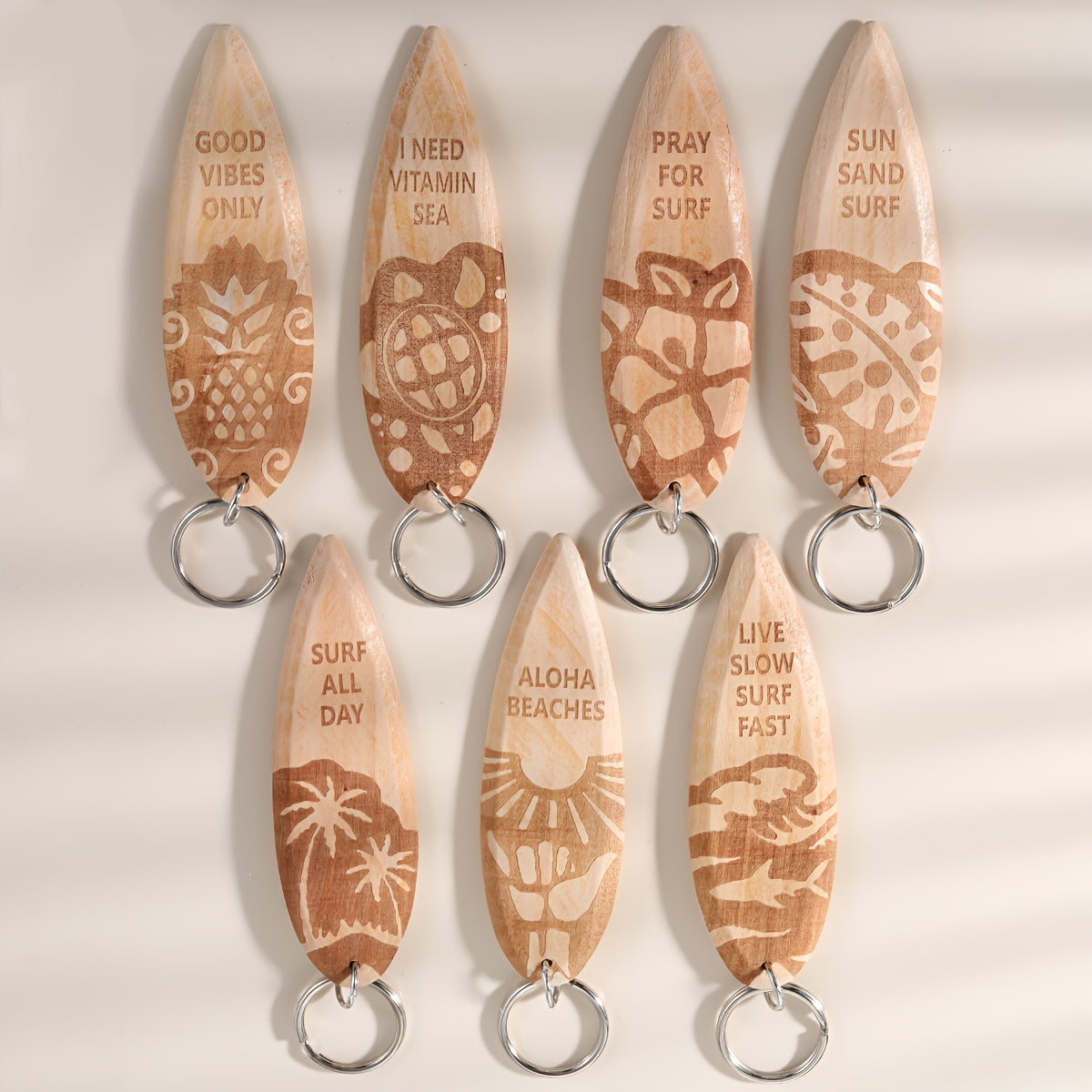 Set of 7 wooden keychains shaped like surfboards, perfect for beach parties or as a fun favor for purses or backpacks. Miniature surfboard pendants that make a great addition to any keychain collection.