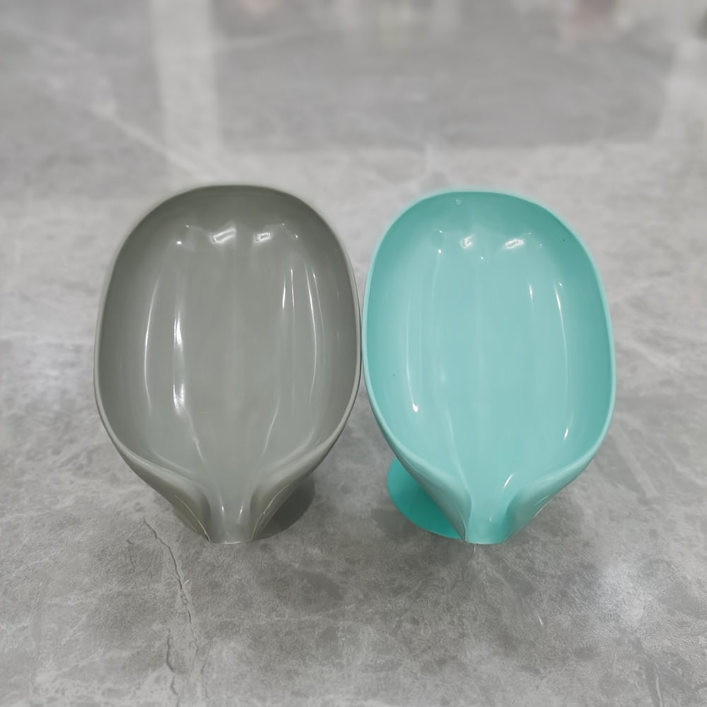 Plastic oval soap dish with suction cup design for home use.