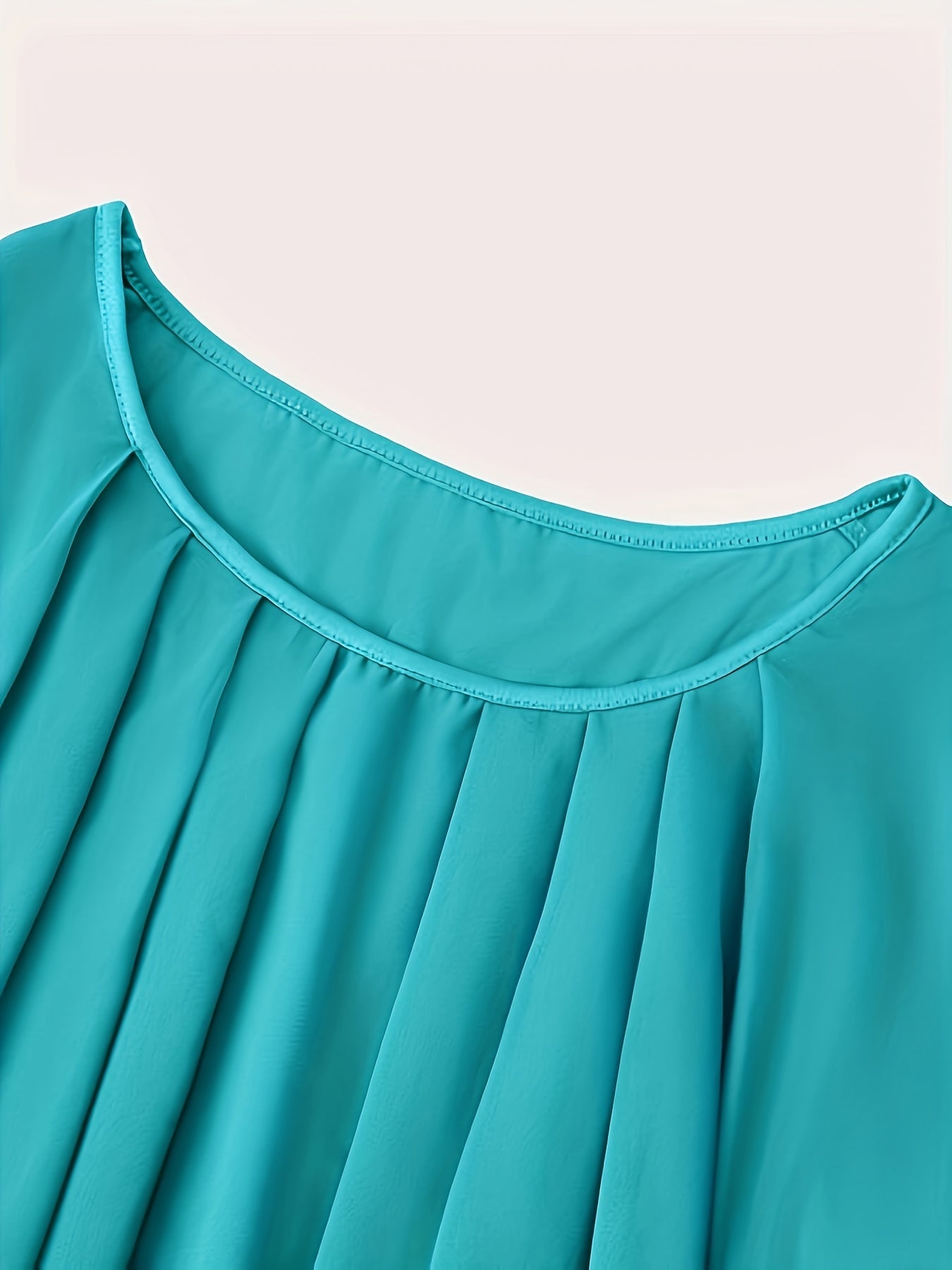 Solid pleated top with crew neck and batwing sleeves, perfect for spring and summer in plus sizes.