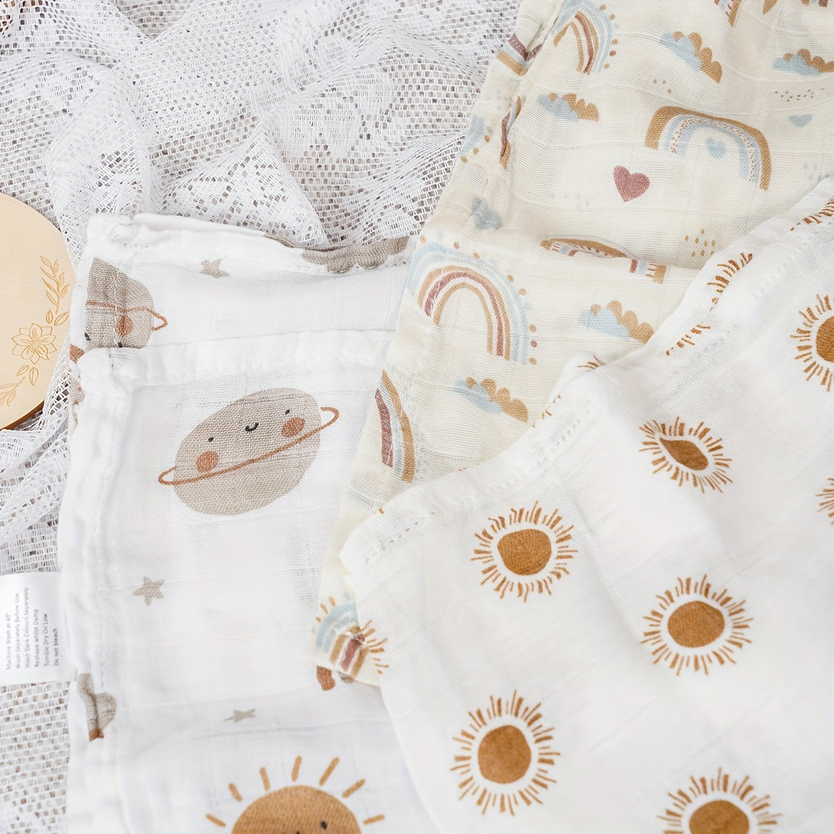 Three Elinfant Swaddle Blankets made from bamboo cotton muslin for newborns. These soft gauze bath towels are recommended for hand washing only and are suitable for children aged 0-3 years old.