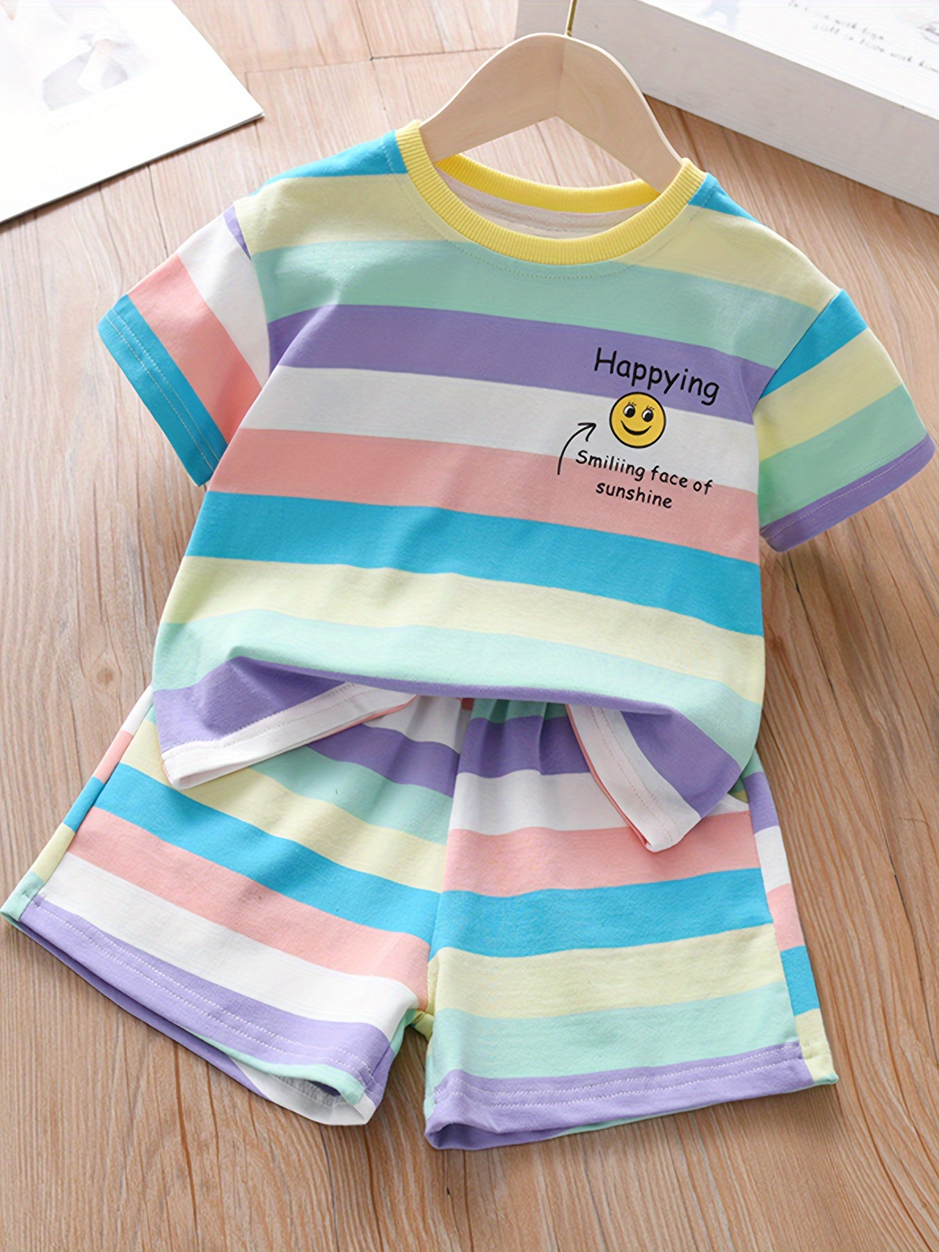 Summer fashion set for girls: Cute T-shirt with joyful face & letter print paired with striped shorts. Made of cotton blend, machine washable, ideal for outdoor activities.