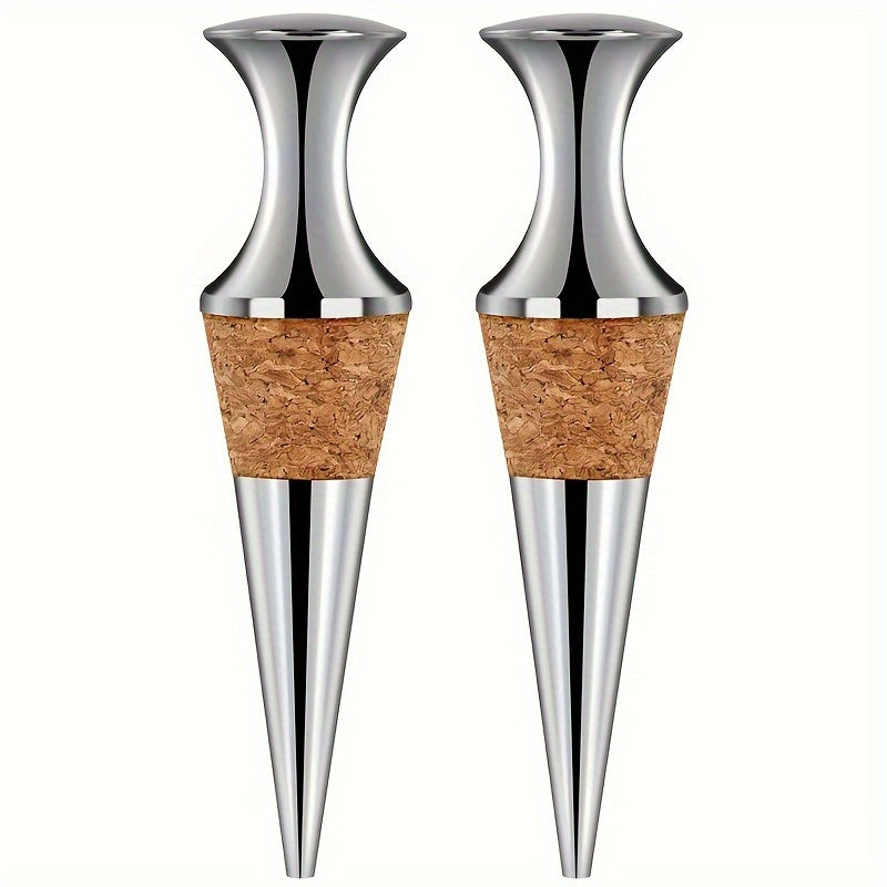 Two silver wine stoppers with wooden plugs.