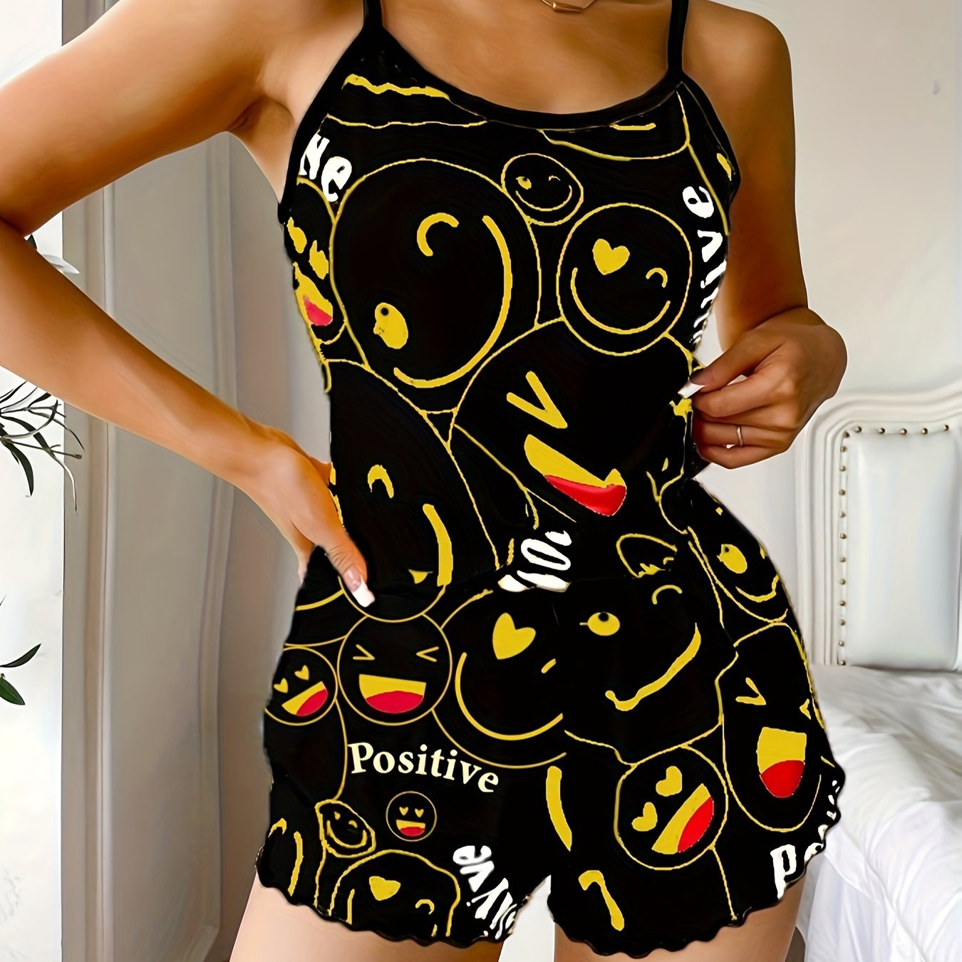 Women's sleepwear set with smiling face print cami top and elastic shorts.