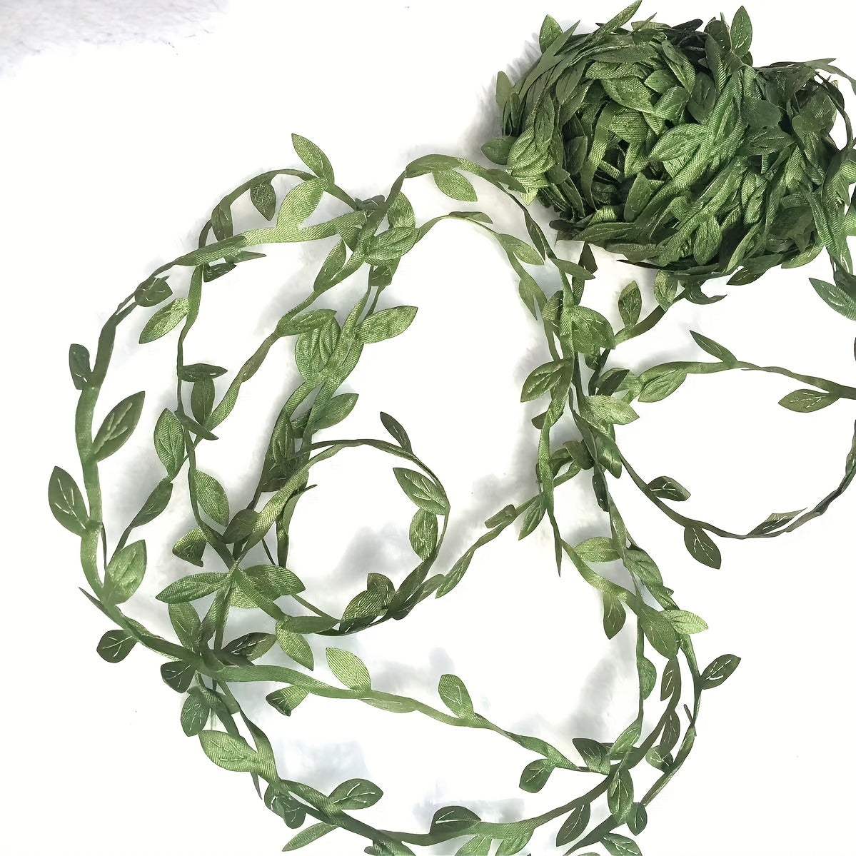 20m pack of lush green faux leaf vines - perfect for DIY wreaths, home decor, and gift wrapping. Versatile artificial greenery for weddings, engagements, and hanging artificial flowers.