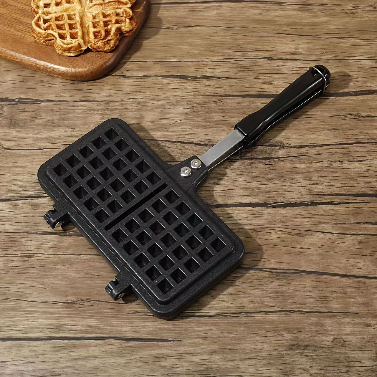 Get ready to make delicious double-sided waffles at home with this durable aluminum alloy waffle maker featuring non-stick plates and a long handle for easy flipping.