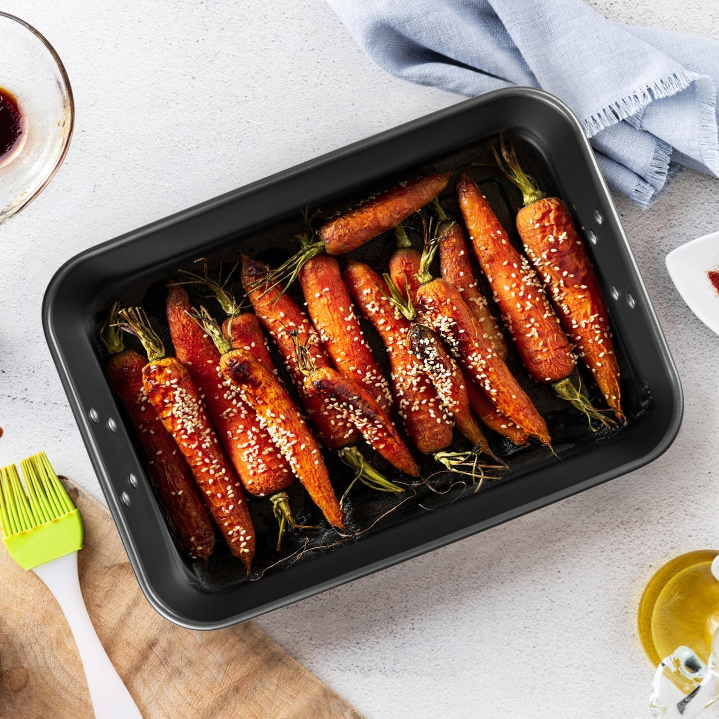 Non-stick roasting pan with handles measuring 38.1x25.4 cm, this heavy-duty square baker is PFOA/Lead/Cadmium free. The oven-safe rectangular cake pan is perfect for making brownies and lasagna, and can be used without power.