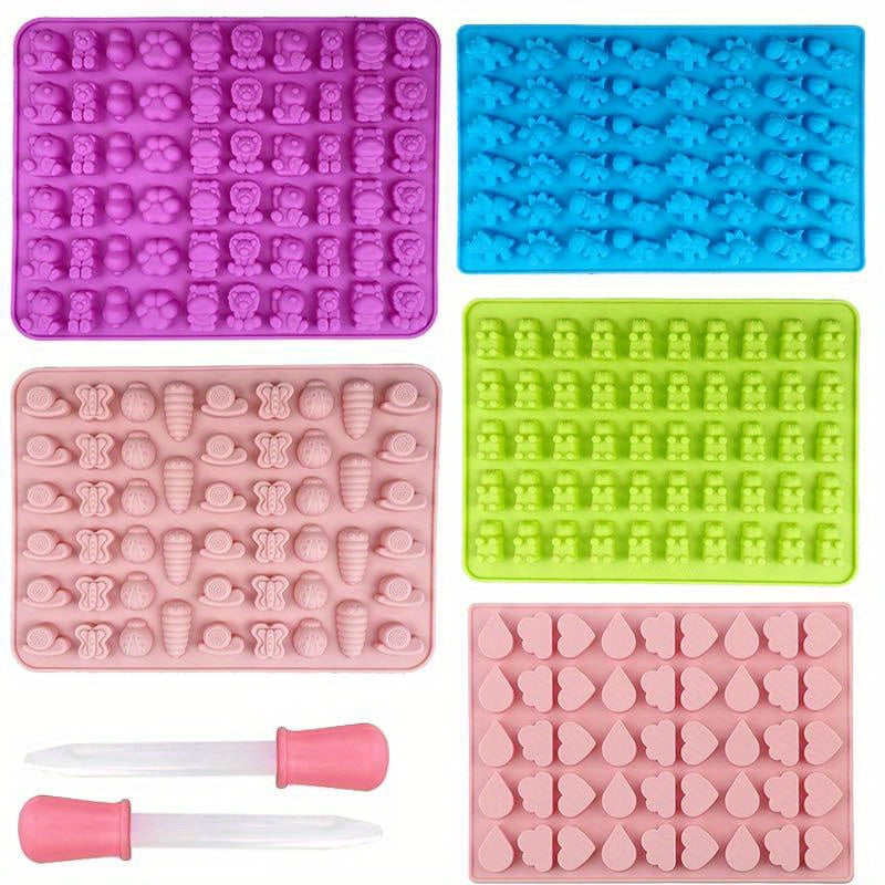 Set of 1 Gummy Bear Mold and 5 additional Candy Molds, made from BPA Free Silicone. Includes two droppers and designs such as bears, dinosaurs, animals, insects, and clouds. Ideal for making fondant, chocolate, and other candies.