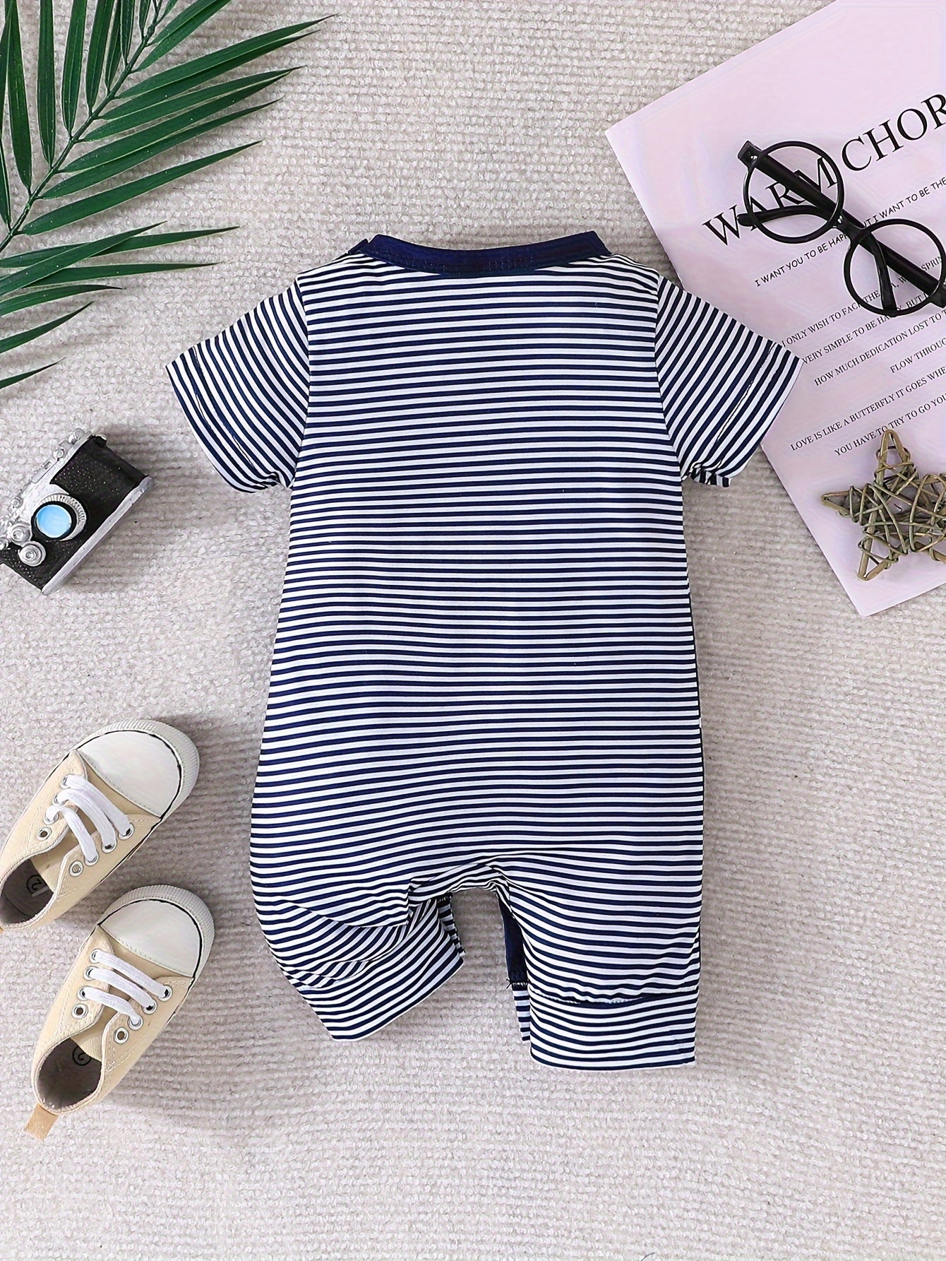 Baby's faux two-piece cartoon star print bodysuit, casual short sleeve romper for outdoor wear.