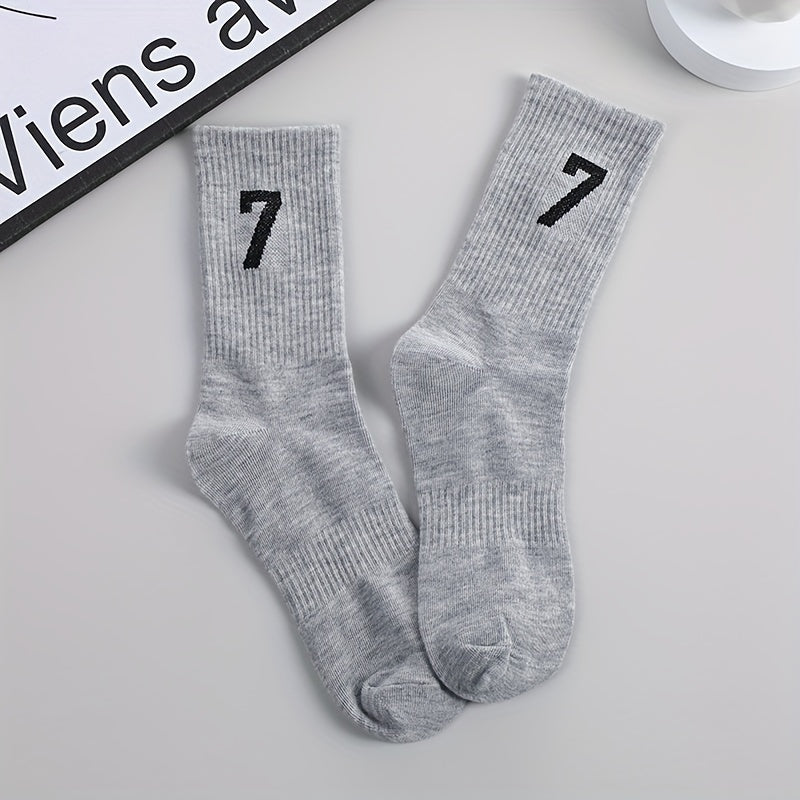 3 pairs of men's mid-calf socks with 17.78cm trendy design in black, white, and gray colors. Made of soft polyester/spandex blend, breathable and sweat-absorbent. Casual athletic wear