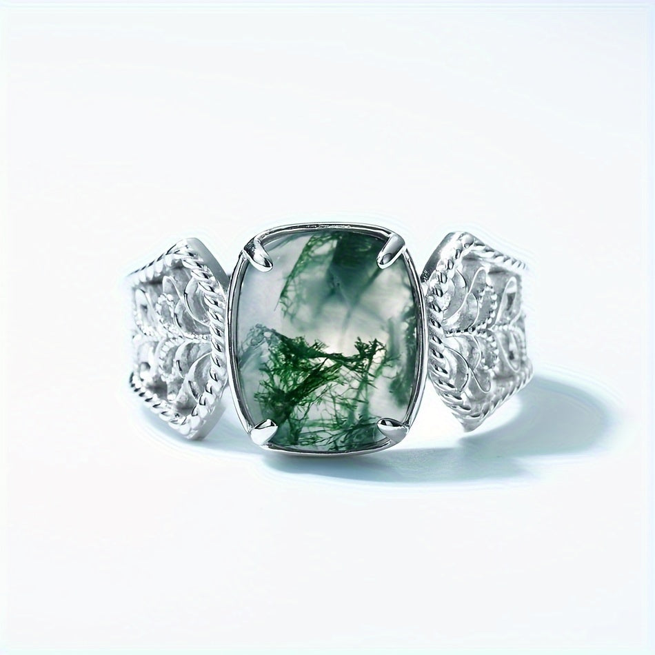 The Vintage-Inspired Green Moss Agate Open Ring is a timeless piece made with 2.4CT of stunning green moss agate set in S925 sterling silver. This elegant ring is perfect for both daily wear and gifting. Featuring a unique water grass design, the stone