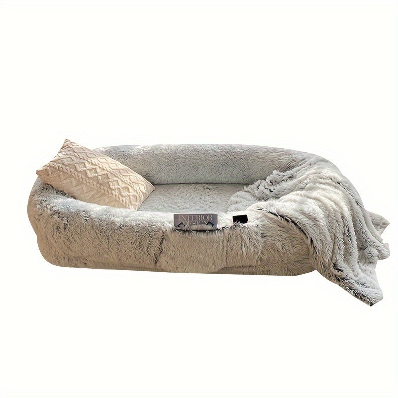 Oval-shaped plush sofa bed for dogs and people, cozy and warm with a non-slip bottom and machine washable in gray color.