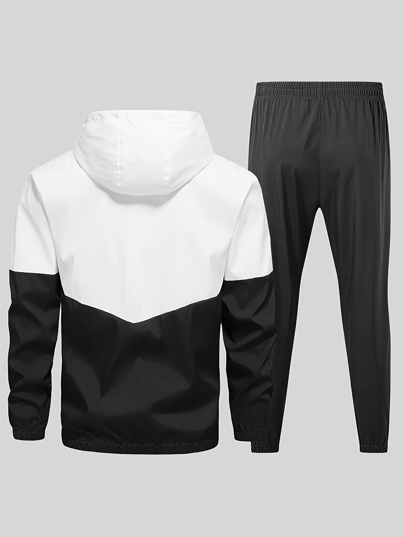 Casual men's sports suit with hooded jacket and pants, featuring a trendy color block design. Made of polyester with slight stretch, drawstring detail, and regular fit.