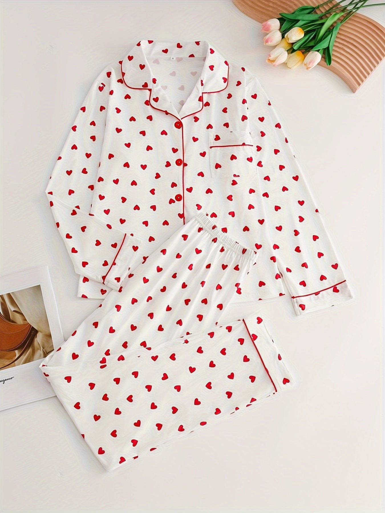 Elegant lady's pajama set for spring/autumn with long sleeve top and heart pattern, paired with cozy pants for home comfort.