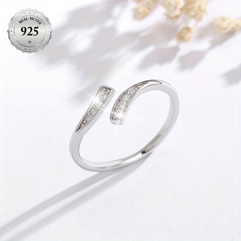 A stylish women's open ring featuring an infinity symbol and an endless loop design adorned with sparkling synthetic cubic zirconia for added bling. This minimalist and classic piece is made from lightweight 1.5g 925 sterling silver, making it suitable