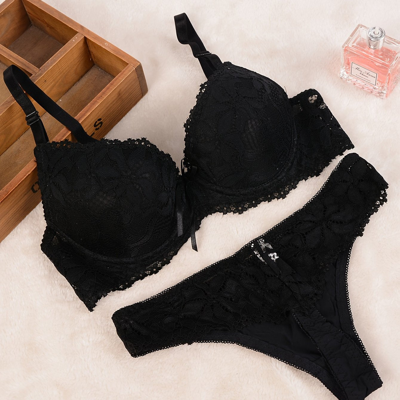 Luxurious black lace lingerie set for women includes push-up bra and matching thong with intricate floral design in comfortable, non-see-through nylon blend.