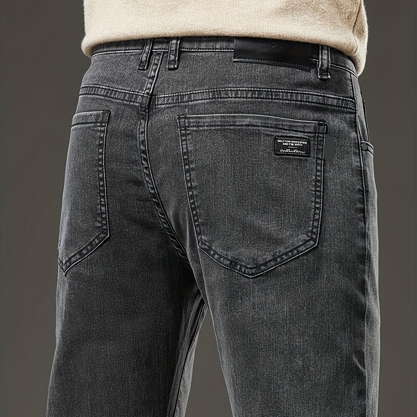 Slim fit men's jeans made of stretch denim in a solid color with washed details, suitable for year-round wear.