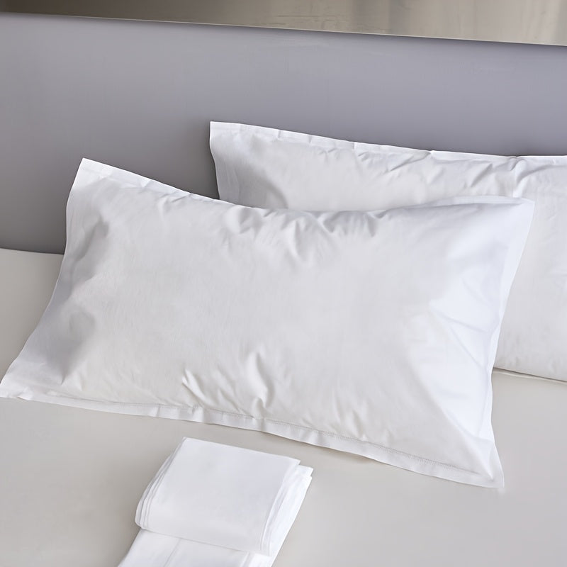 Two pieces of sterile disposable travel pillow covers with sealed envelopes. They are partially cleaned, pure white, and made of thick breathable non-woven polyester. Ideal for travel, hotels, and salons. The covers are unprinted and come in a pair. Use