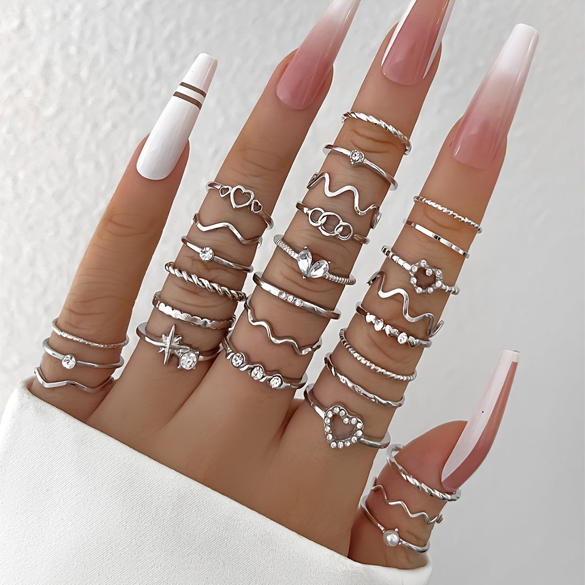 A 28-piece set of stylish alloy iron stacking rings with heart, geometric, and wavy designs for versatile wear.