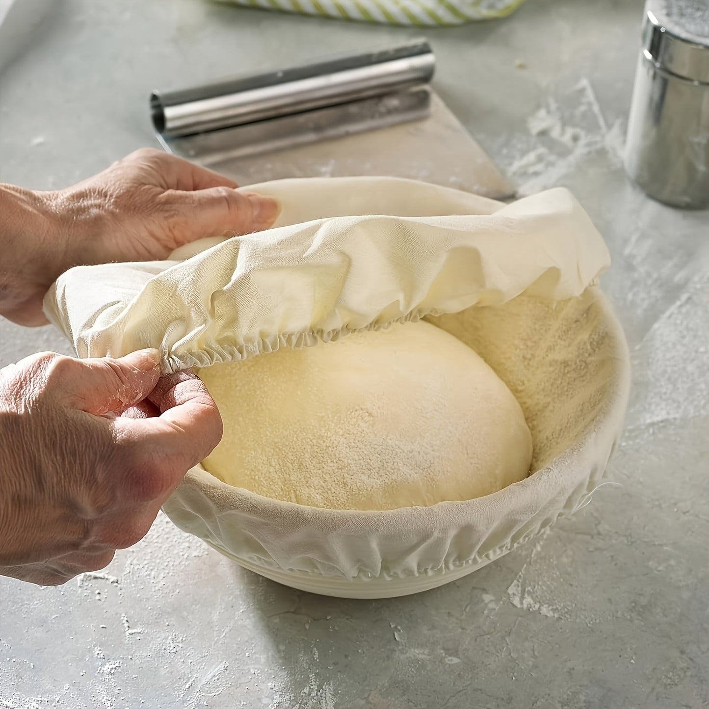 Set of two modern round bread proofing baskets with liners made from rattan. This banneton basket kit is ideal for baking artisan sourdough bread, providing a non-stick fermentation basket for home bakers and bread making.