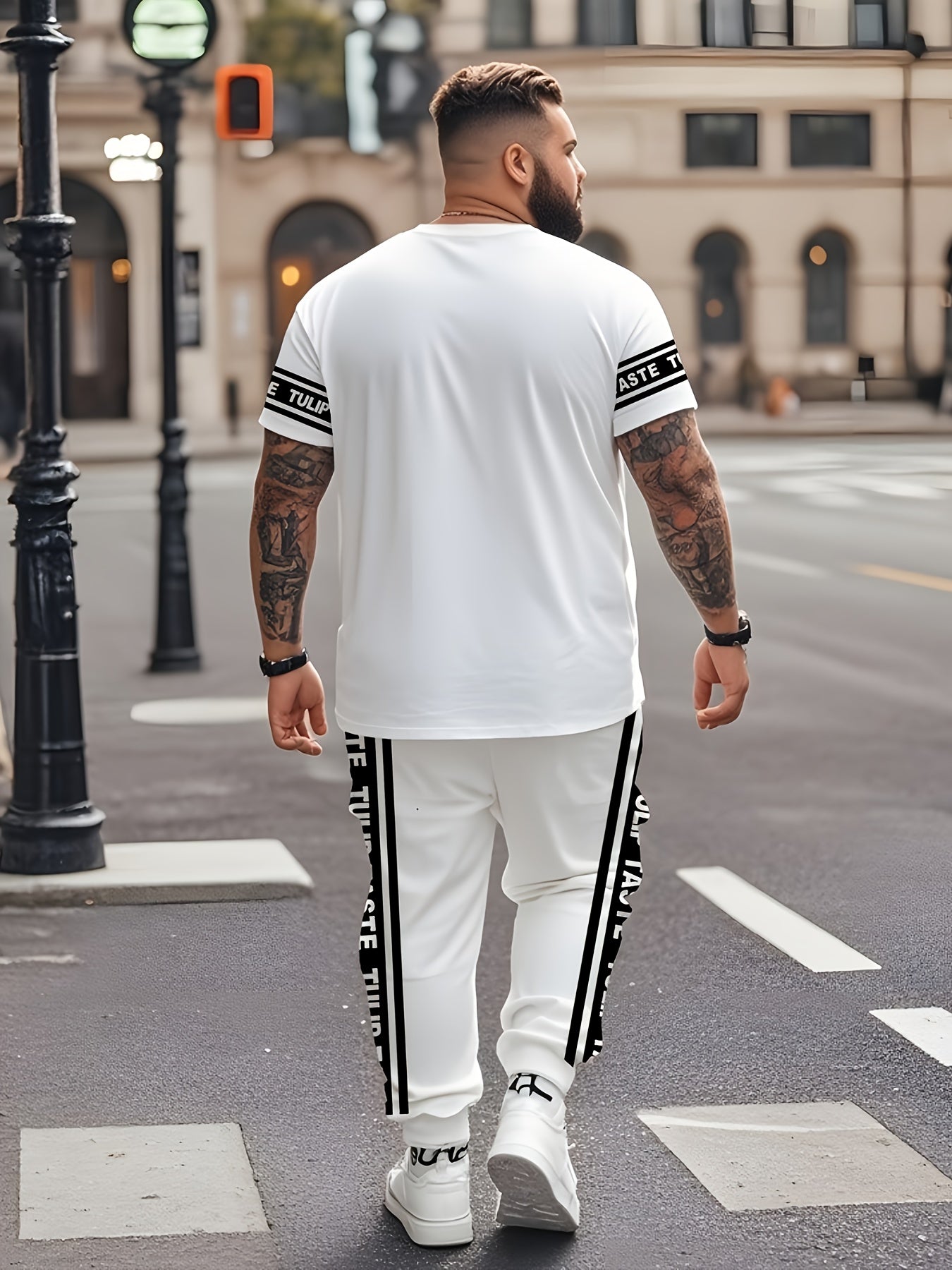 Plus size urban style black and white striped men's t-shirt and pants set featuring mixed print Paris letter street culture design, perfect for trendy summer streetwear.