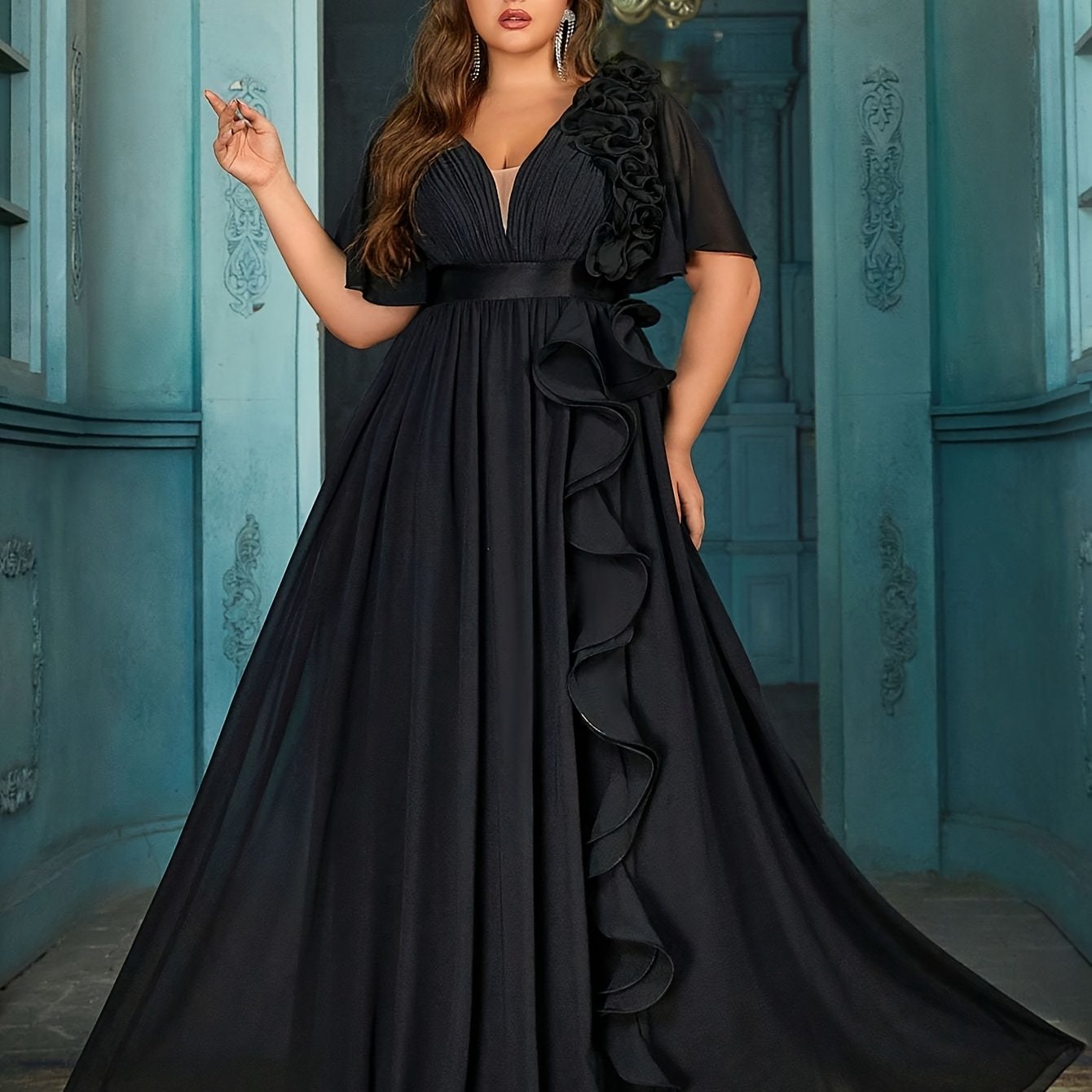 Stylish Plus Size Black Chiffon Evening Gown with V-Neck, 3D Floral Detail, Ruffled Hem, Short Sleeves, and High Waist. Perfect for weddings, graduations, and formal occasions.