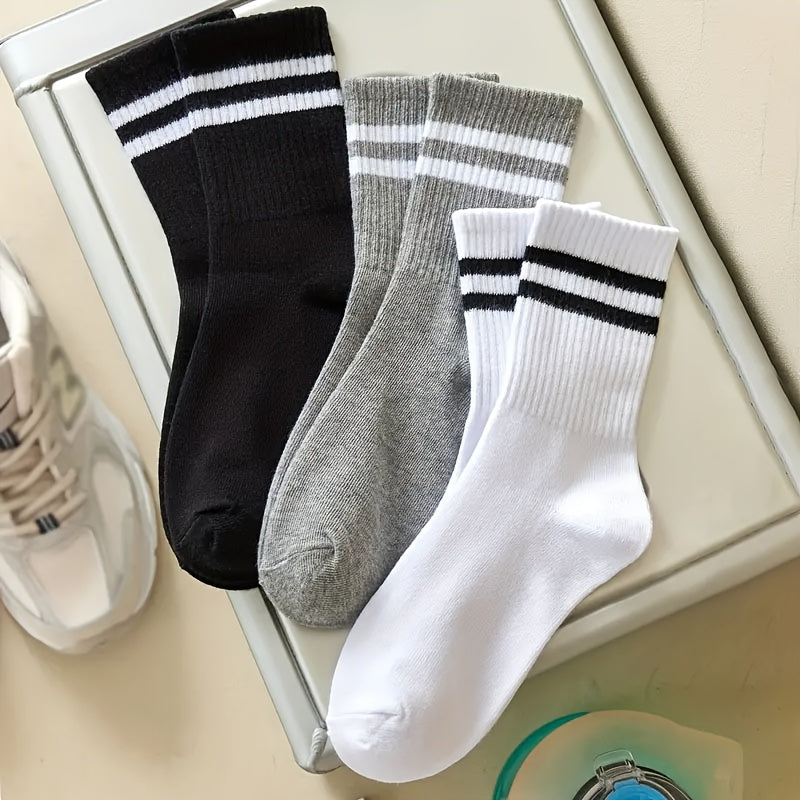 3 pairs of knee-length striped socks for women in black, white, and grey. Made of breathable polyester knit fabric with a casual sport style. Hand wash or dry clean.