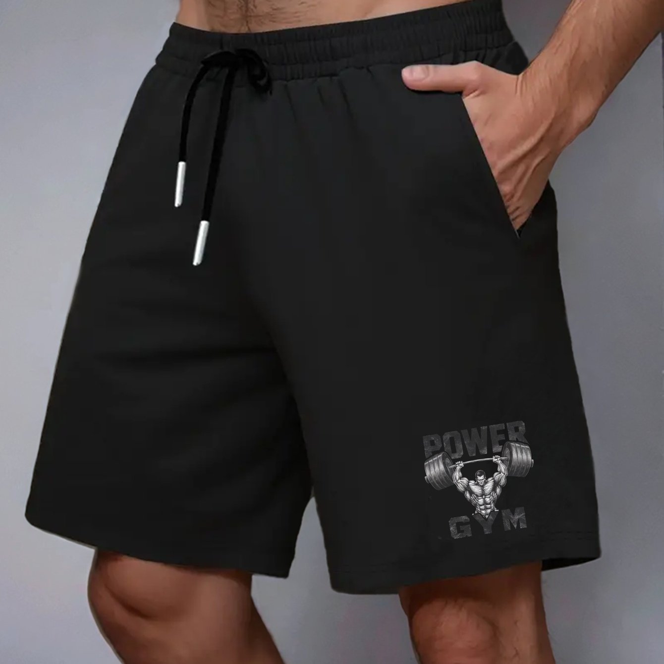 Power Gym Men's casual shorts made of 100% polyester non-stretch woven fabric. Features regular fit with pockets and a muscular barbell print. Big and tall sizes, plus sizes available.