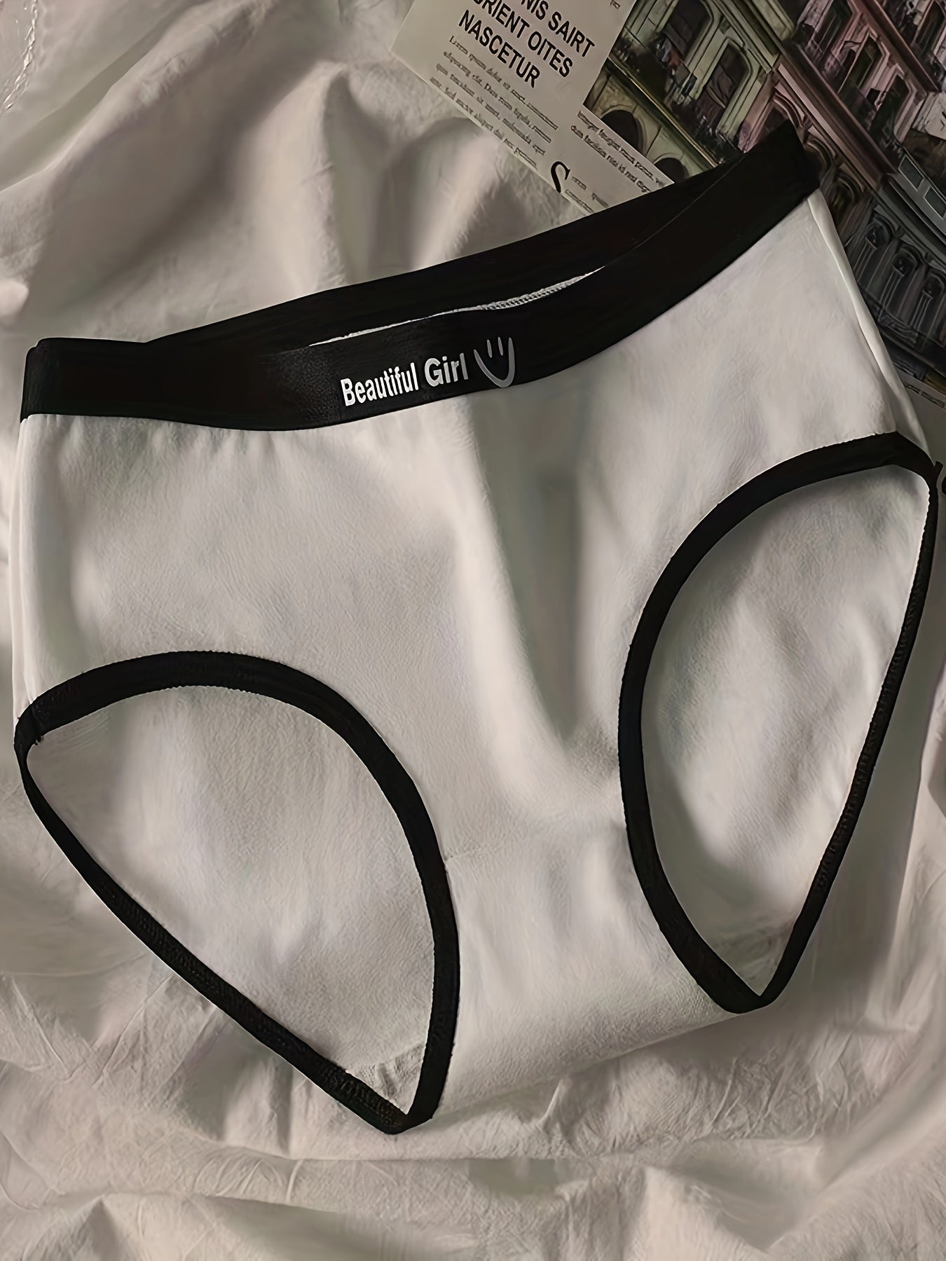 Women's period panties made with seamless, breathable fabric in black and white with joyful face design, perfect for casual wear and cute style.