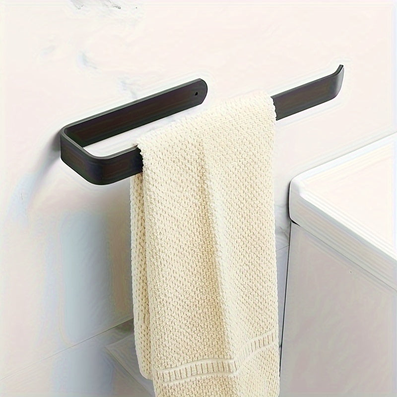 Self-adhesive wall-mounted toilet paper holder for home bathrooms.